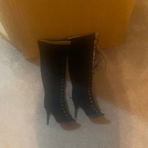 Thigh high, peep toe, lace up boots.